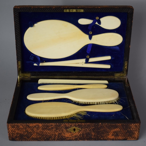 167 - A Late Victorian Cased Ivory Dressing Set with Brushes Mirror, Glove Stretcher, Comb etc in Leather ... 