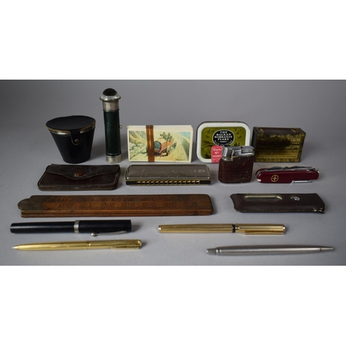 228 - A Collection of Curios to Include Various Vintage Pens Mouth Organ, Ruler, Pocket Lighter (We Can't ... 