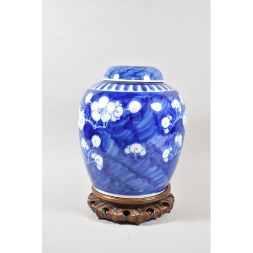 259 - A Good Pair of Large Oriental Prunus Pattern Ginger Jars with Covers on Pierced Wooden Stands, Four ... 