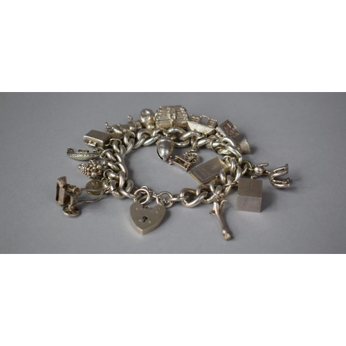 389 - A Silver Charm Bracelet with Silver and White Metal Charms, Total Weight 85.2g