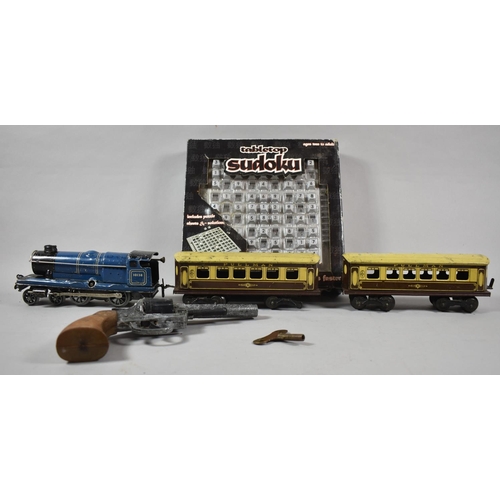 404 - An O Gauge Clockwork Locomotive and Two Carriages Together with a Toy Revolver and Sudoku Game