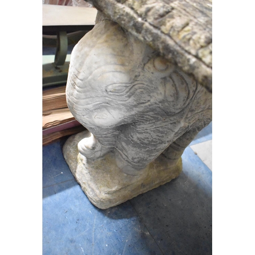 434 - A Reconstituted Stone Crescent Shaped Garden Seat on Elephant Supports, 108cm wide