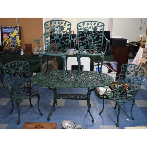 449 - A Cast Metal Patio Set Comprising Oval Table, 137cm Wide and Four Arm Chairs