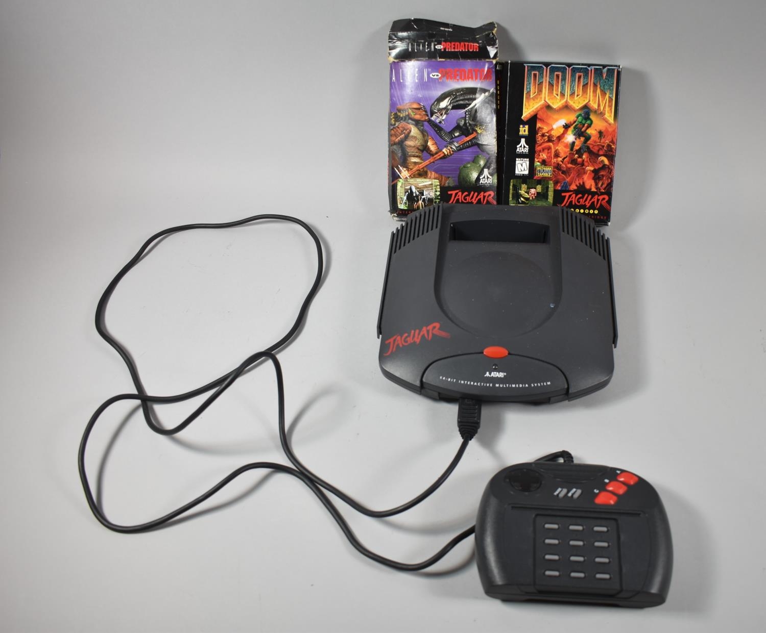 An Atari Jaguar Interactive Multimedia System with Two Games, Doom and  Alien Vs Predator, Missing Po