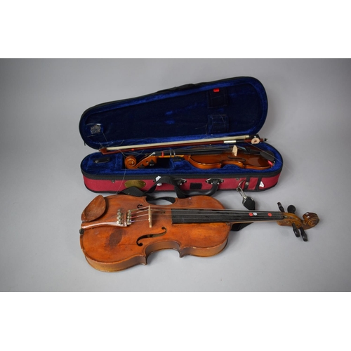 101 - An Early 20th Century Child's Spruce Topped Violin together with a Cased Smaller Example