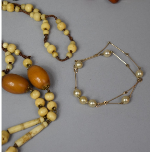 127 - A Collection of Various Necklaces to Include Amber and Amber Style Beads, Glass, Yellow Metal and Ea... 