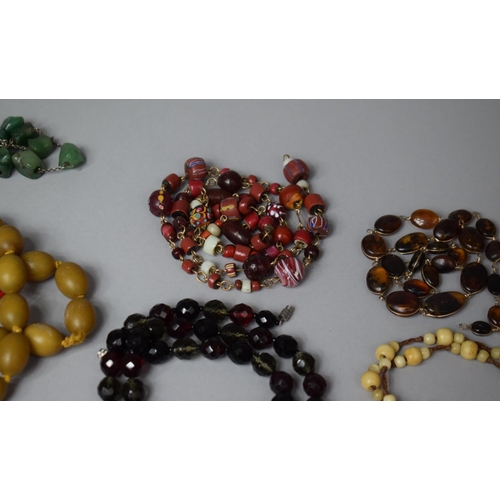 127 - A Collection of Various Necklaces to Include Amber and Amber Style Beads, Glass, Yellow Metal and Ea... 