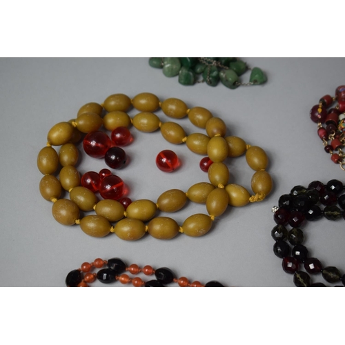 127 - A Collection of Various Necklaces to Include Amber and Amber Style Beads, Glass, Yellow Metal and Ea... 