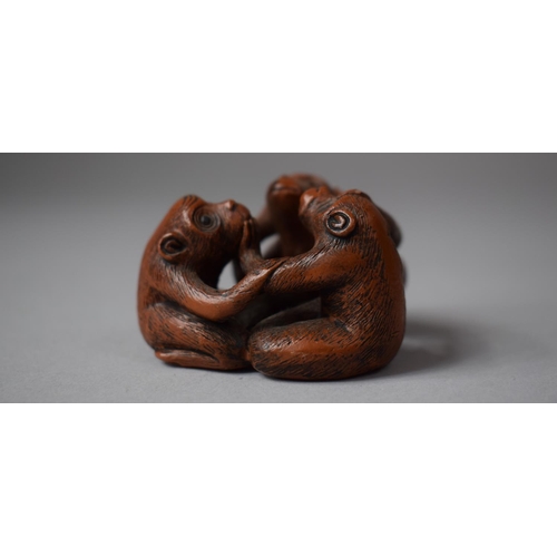 154 - A Carved Wooden Netsuke in the Form of Three Entwined Monkeys, Signed to Base