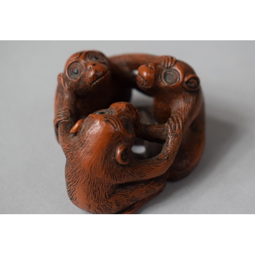 154 - A Carved Wooden Netsuke in the Form of Three Entwined Monkeys, Signed to Base