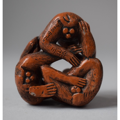 154 - A Carved Wooden Netsuke in the Form of Three Entwined Monkeys, Signed to Base