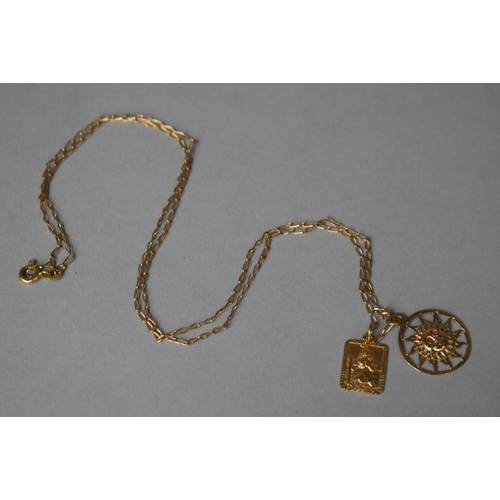 311 - A 9ct Gold St Christopher and Sun Pendant on a 9ct Gold Chain. 3.4gms