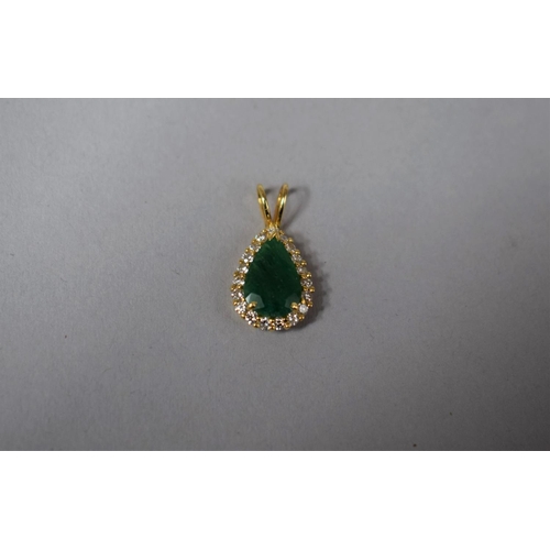 318 - A Gold, Diamond and Emerald Pendant of Tear Shape. 2.1gms