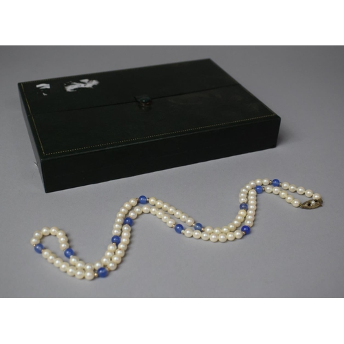 325 - A String of Pearls and Blue Glass Beads having Silver Clasp Stamped 935