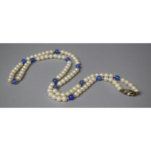 325 - A String of Pearls and Blue Glass Beads having Silver Clasp Stamped 935