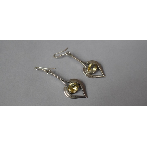 338 - A Pair of Arts and Crafts Style Silver and Citrine Drop earrings in the Form of Stylised Hearts