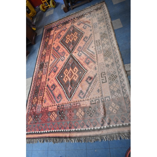 438 - A Turkish Kilim Carpet with Two Central Lozenge Shaped Medallion Design, 189x313cms, worn