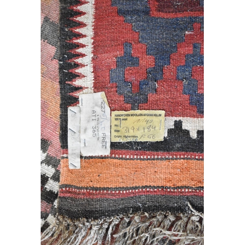 438 - A Turkish Kilim Carpet with Two Central Lozenge Shaped Medallion Design, 189x313cms, worn