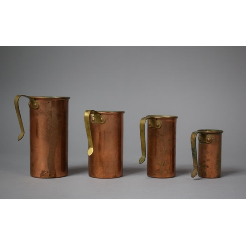 24 - A Set of Four Copper and Brass Handled Cup Measures of Cylindrical Form, Largest 11.5cm high