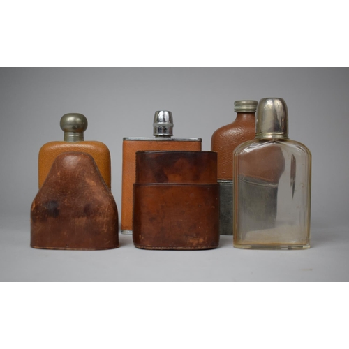 76 - A Collection of Four Vintage Leather Mounted Hip Flasks