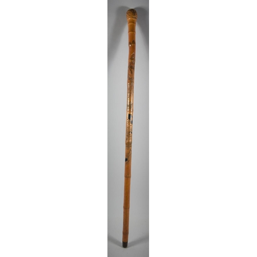 A Mid 20th Century Poacher's Fishing Rod Disguised as a Bamboo Walking Stick  Having Carved Decoratio