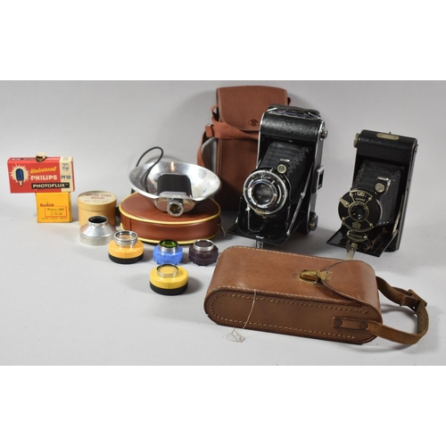 149 - A Collection of Various Photographic Items to Include Canvas and Leather Cased Cameras, Lens Hoods, ... 