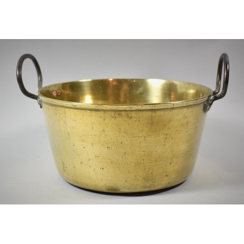 46 - A Vintage Brass Jam Kettle with Two Iron Loop Handles, 28.5cm diameter