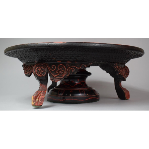 92 - An Oriental Lacquered Lazy Susan with Three Scrolled Carved Feet, 46cm Diameter