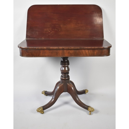 105 - A George IV Mahogany Tea Table with Hinged Top on Turned Support with Four Scrolled Feet Culminating... 