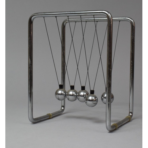 134 - A Late 20th Century Chromed Framed Desktop Newton's Cradle, 15cm wide