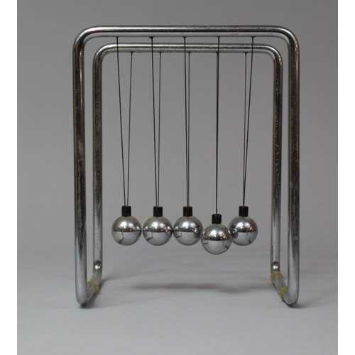 134 - A Late 20th Century Chromed Framed Desktop Newton's Cradle, 15cm wide