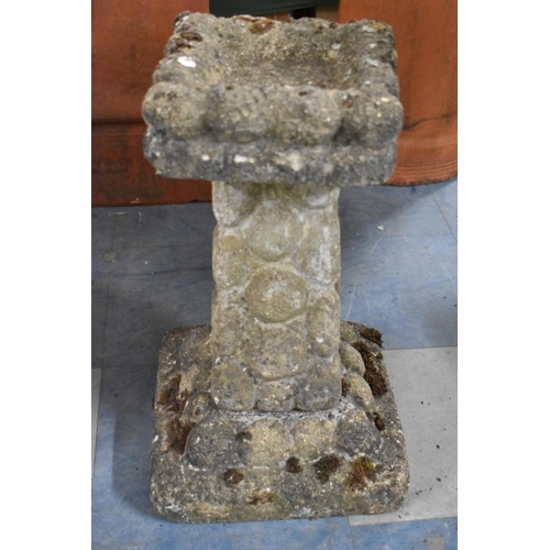 551 - A Reconstituted Stone Square Topped Bird Bath on 'Pebble' Support, 52cm high