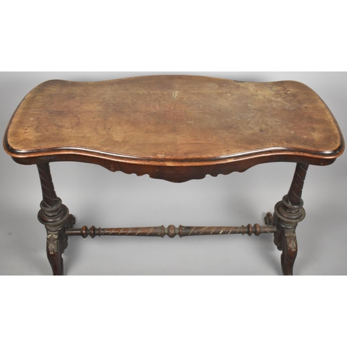 645 - A Victorian Walnut Serpentine Shaped Side Table on Turned Supports with Scrolled Seet, 97cm Wide