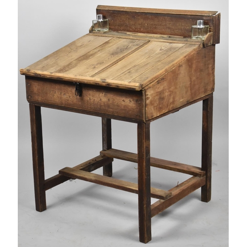 653 - A Late 19th/Early 20th Century Childs Desk with Hinged Sloping Writing Surface, Two Ink Bottles and ... 