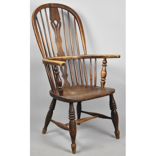 667 - An Elm Seated Hooped Back Windsor Armchair with Pierced Splat