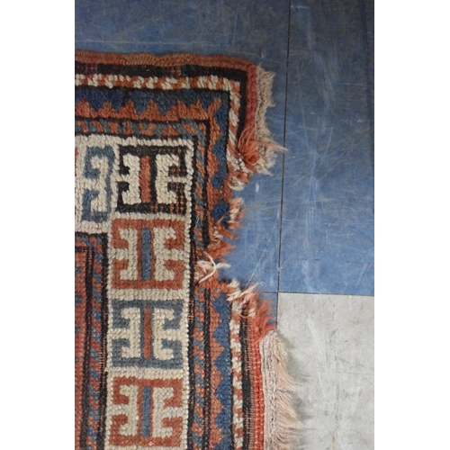 671 - A Patterned Woollen Rug, 186cmx102cm