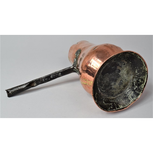 36 - An Early Iron handled Copper Side Pouring Jug, 18cm high
