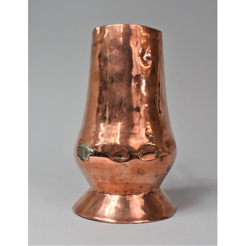 36 - An Early Iron handled Copper Side Pouring Jug, 18cm high