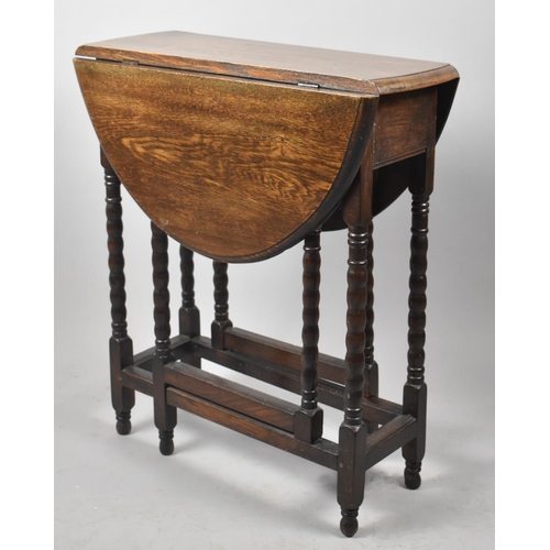 114 - A Mid 20th Century Oak Bobbin Gate Leg Drop Leaf Narrow Occasional Table with Oval Top, 61cm Long