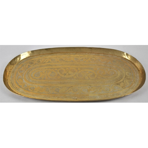 115 - An Indian Oval Brass Tray with Hand Hammered and Engraved Decoration, 48cm wide