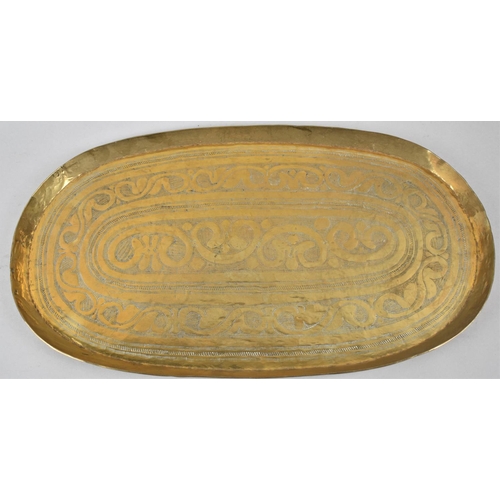 115 - An Indian Oval Brass Tray with Hand Hammered and Engraved Decoration, 48cm wide