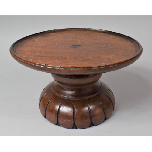 128 - A Turned Mahogany Circular Stand, 25.5cm Diameter and 15cm high