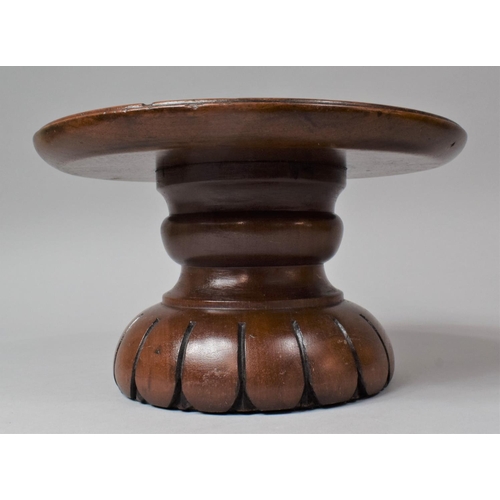 128 - A Turned Mahogany Circular Stand, 25.5cm Diameter and 15cm high