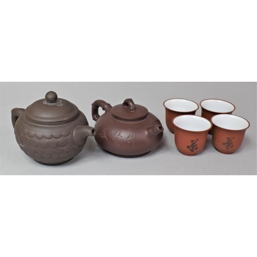 261 - Two Chinese Yixing Miniature Teapots and a Set of Four  Vessels