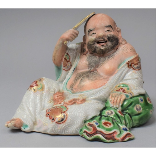 263 - A Japanese Porcelain Figure of Reclining Buddha with Fan, Meiji Period, 13.5cm High