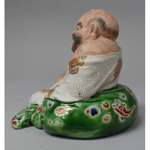 263 - A Japanese Porcelain Figure of Reclining Buddha with Fan, Meiji Period, 13.5cm High