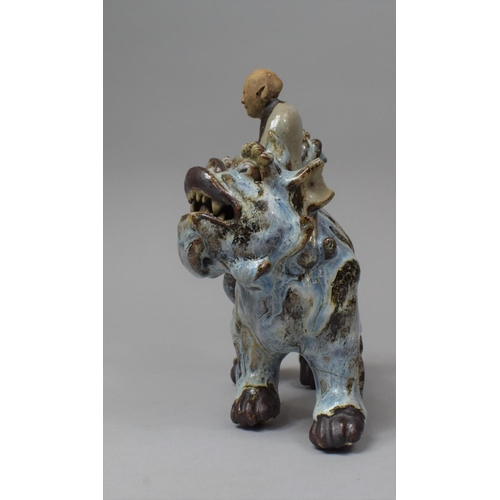 264 - A Chinese Glazed Stoneware Figure Group Depicting Scholar Seated on Temple Lion/Foo Dog, 21cm high