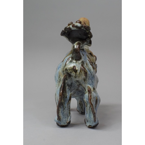 264 - A Chinese Glazed Stoneware Figure Group Depicting Scholar Seated on Temple Lion/Foo Dog, 21cm high