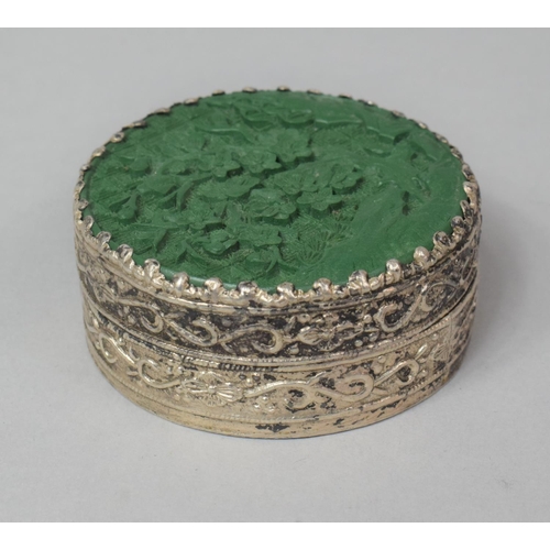 292 - An Oriental White Metal Mounted Circular Box with Green Cinnabar Style Top, 5.5cm Diameter