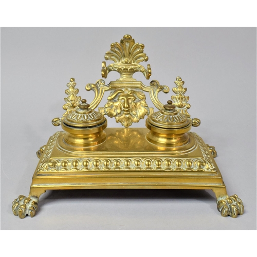 12 - A French Brass Desktop Penrest and Two Bottle Inkstand on Four Claw Feet, 24cm Wide